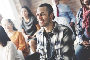 Man sitting in a crowd